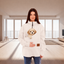 Women wearing a white fleece sweatshirt with a dog in the pocket in a living room