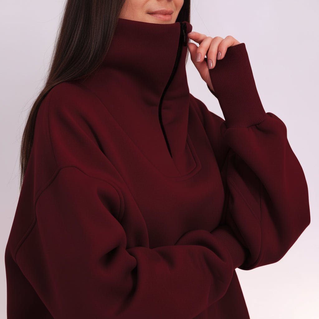Burgundy sweater worn by a person on a white background