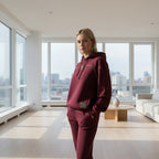 Person wearing a  Burgundy hoodie and pants in living room 