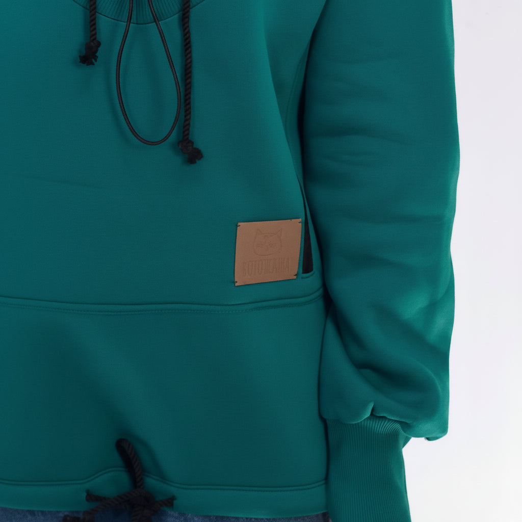Teal hoodie with a brown patch on a white background