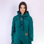 Person wearing a teal hoodie with a white background