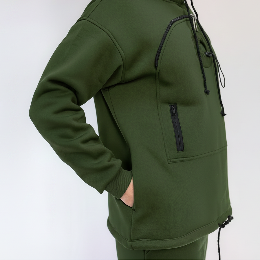 An dark green hooded sweatshirt with black drawstrings and a vertical zippered pocket, shown on a model against a plain light background.