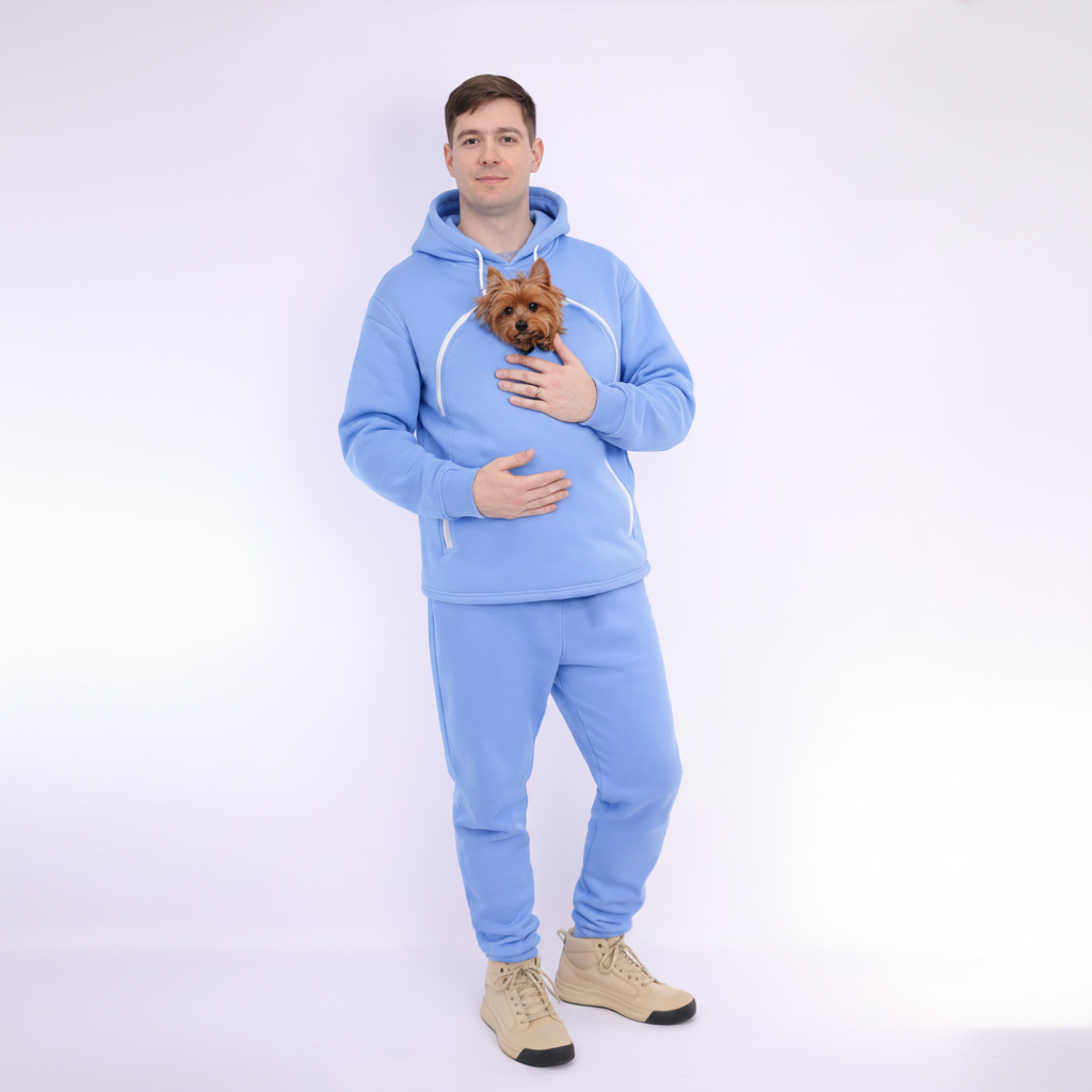 Man wearing a Light Blue tracksuit holding a small dog on a white background Main image