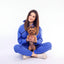 Woman in Royal Blue tracksuit holding a small brown dog on a white background