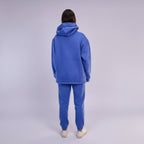 Person wearing a Royal Blue tracksuit on a white background