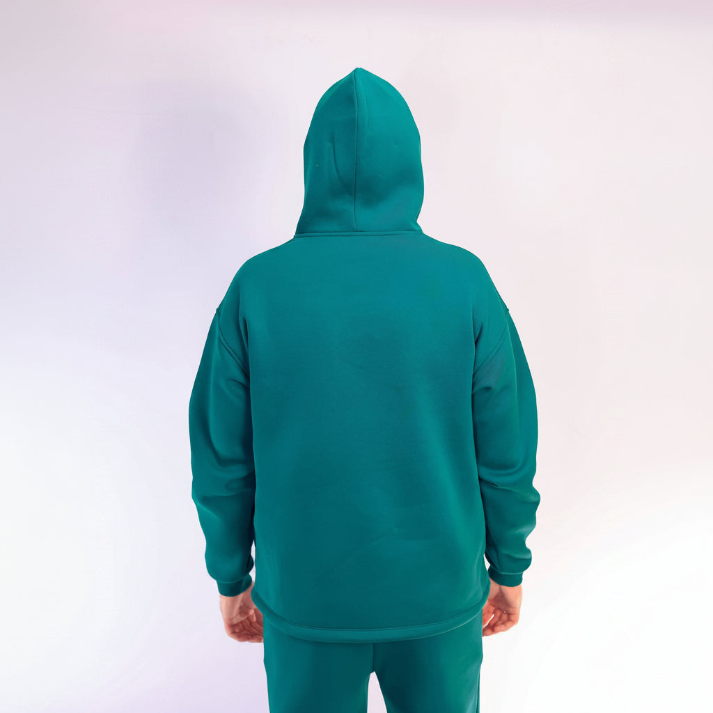 Teal hoodie worn by a person on a white background