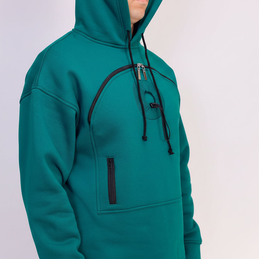 Teal hoodie with black zippers on a light gray background