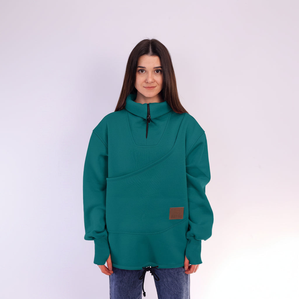 Person wearing a teal sweatshirt with a brown patch on a white background