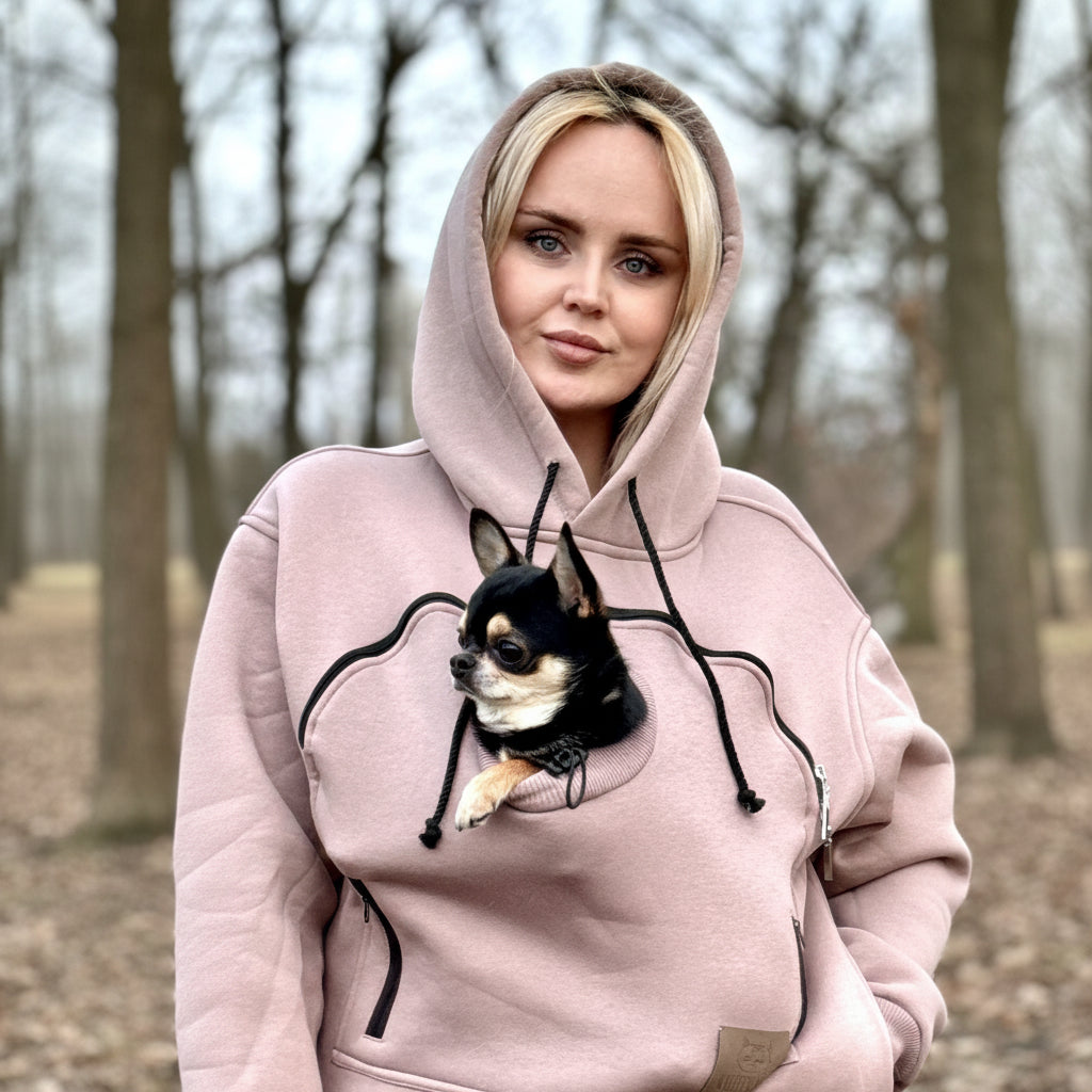 Person wearing a beige hoodie with a dog design, standing outdoors.