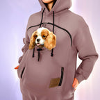 Person wearing a hoodie with a dog face design on a light purple background