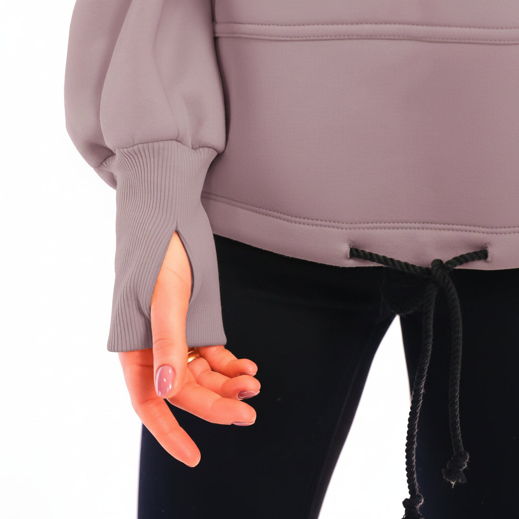 Person wearing a beige  hoodie with a white background