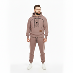 Man wearing a brown tracksuit with a white background