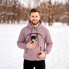 Man wearing a hoodie with a dog graphic in a snowy landscape