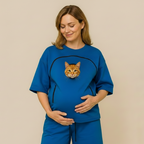 Woman wearing a blue outfit with a cat face design on a beige background