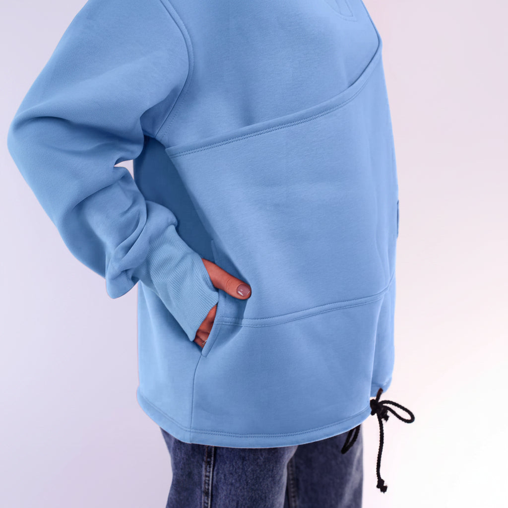 Light blue hoodie worn by a person with a plain background