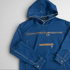 A blue denim hooded jacket with a front zipper pocket and a horizontal zippered chest pocket, laid flat on a light gray background.