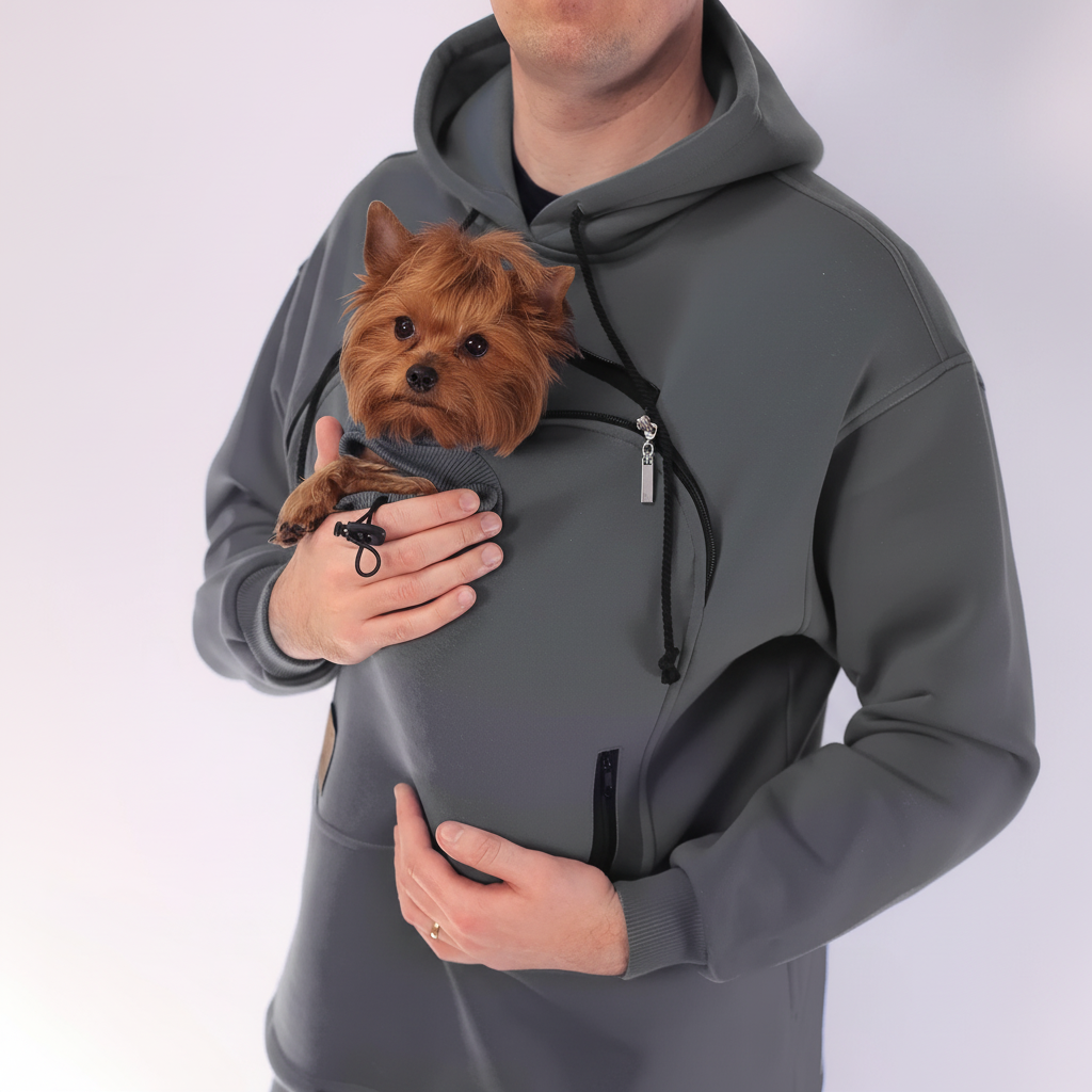 Person wearing a gray hoodie with a front pocket holding a small brown dog. Main image