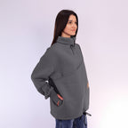 Woman wearing a gray fleece sweatshirt on a white background