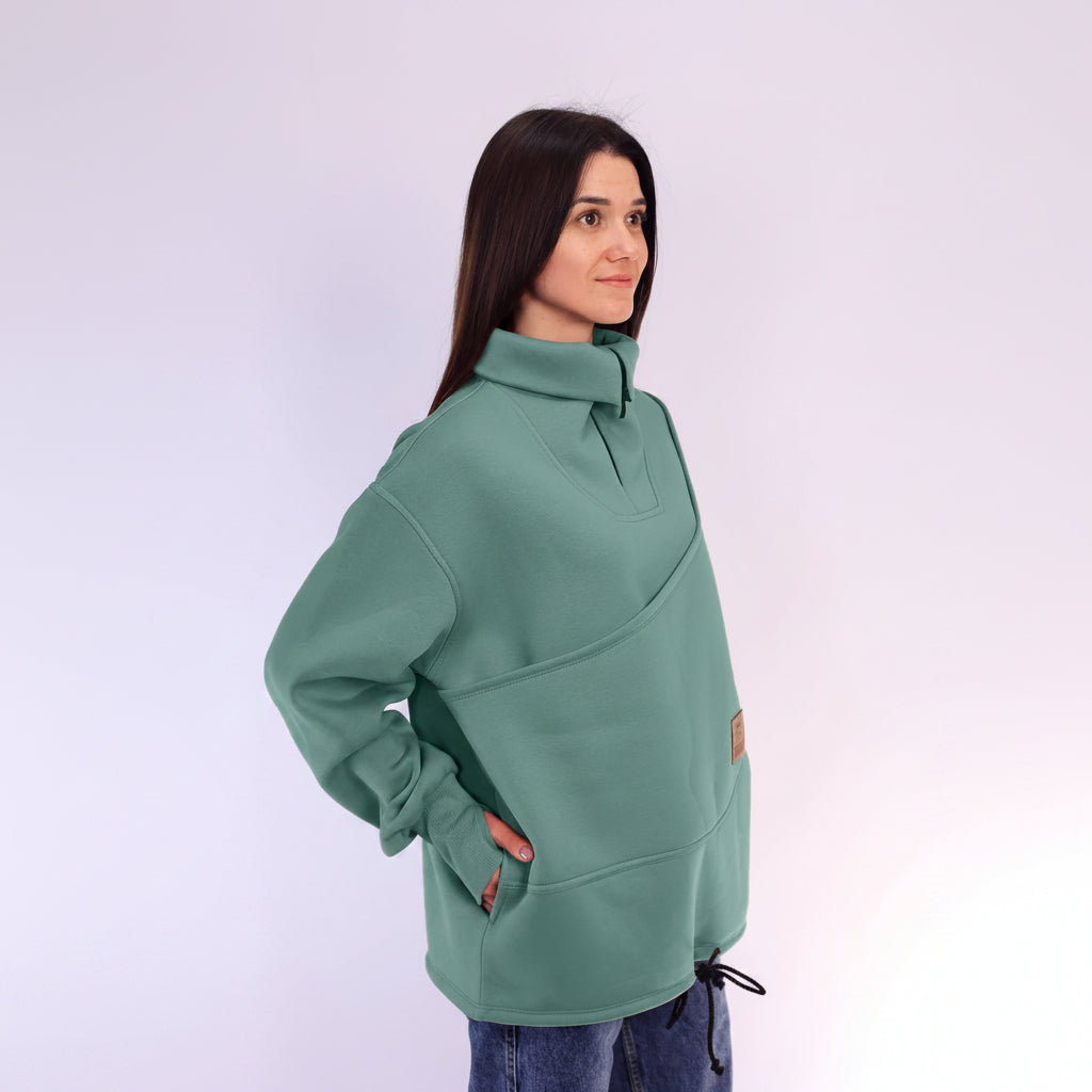 Woman wearing a green sweater with a white background