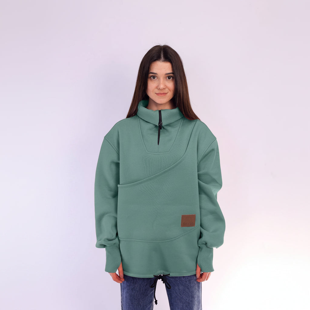 Person wearing a green sweater with a brown patch on a white background