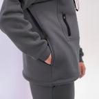 Gray tracksuit with a focus on the hoodie on a light gray background