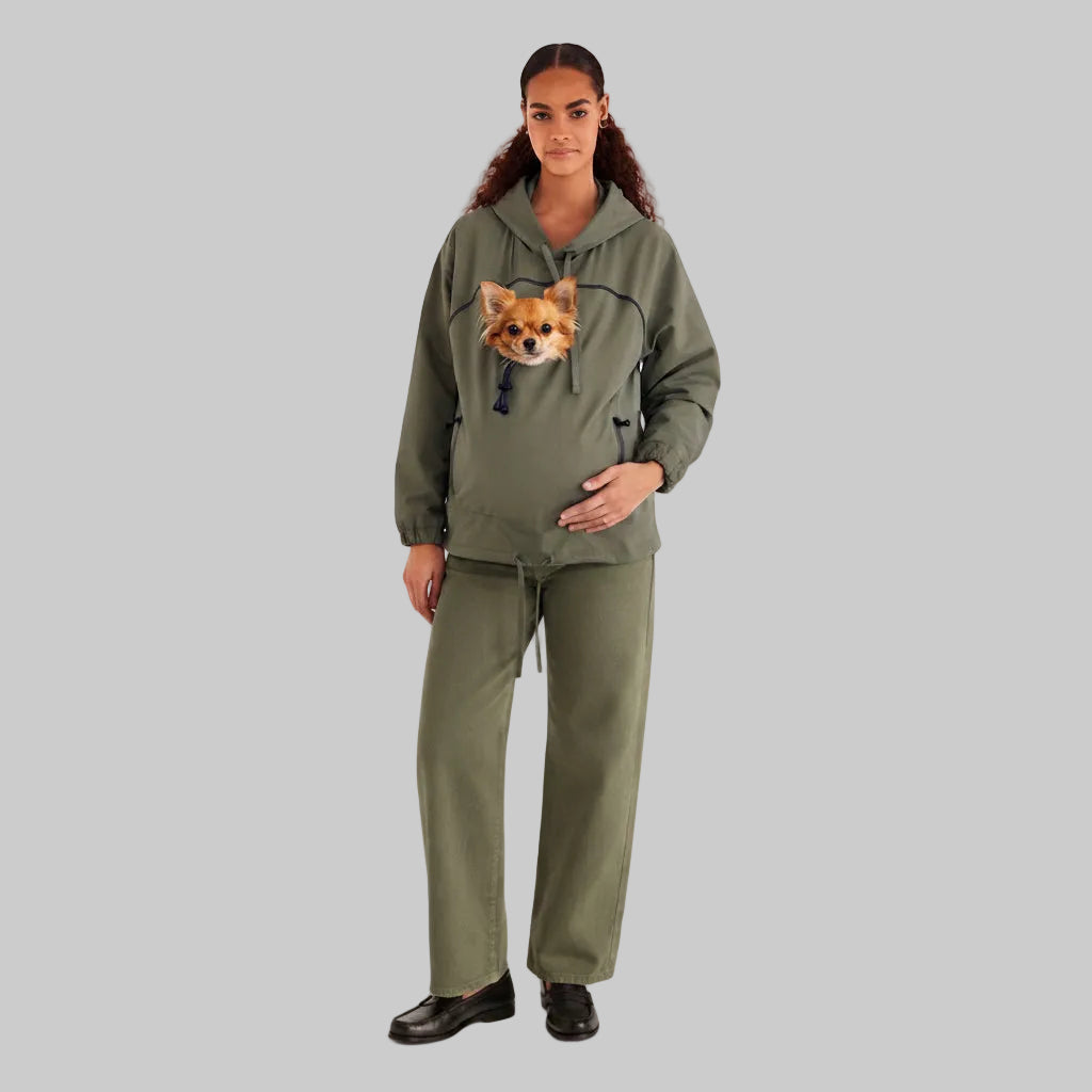 A model wearing an olive green matching loungewear set consisting of a pullover hoodie with a dog face graphic on the chest and matching wide-leg sweatpants, photographed against a light gray studio background. Основне зображення