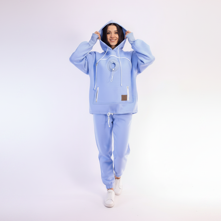 Person wearing a light blue tracksuit on a white background