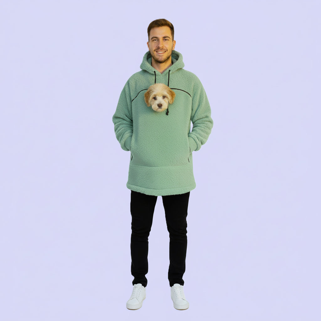 Person wearing a light green hoodie with a dog face design on a light purple background