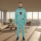 Man wearing a mint tracksuit with a dog graphic in a modern living room.