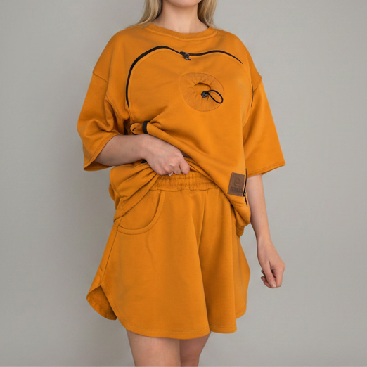Person wearing an orange outfit with a plain background