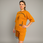 Woman wearing an orange outfit with a gray background