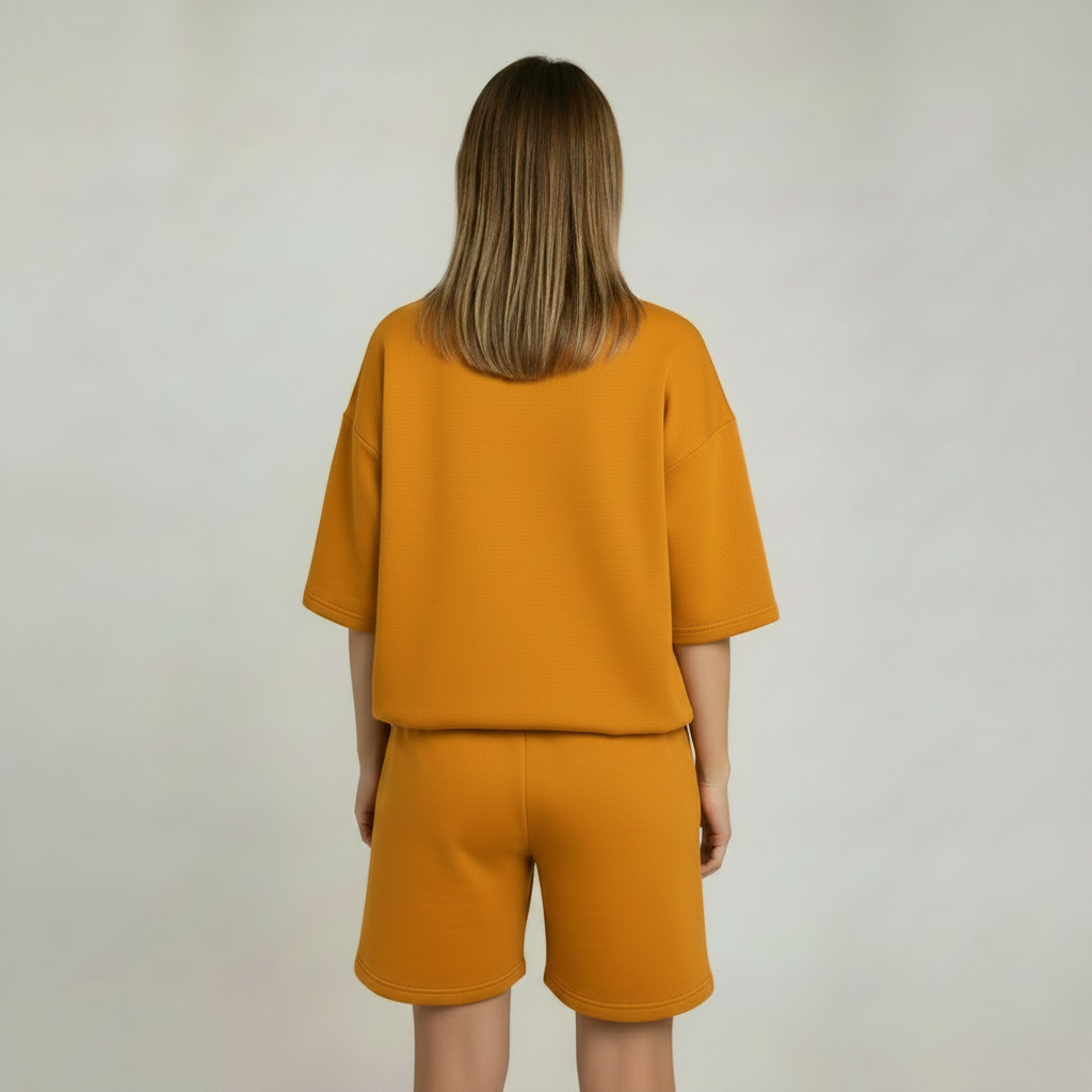 Person wearing a mustard yellow outfit with a plain background