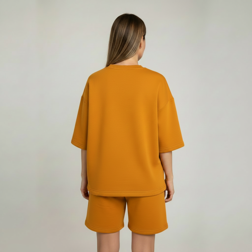 Person wearing a mustard yellow outfit on a plain background