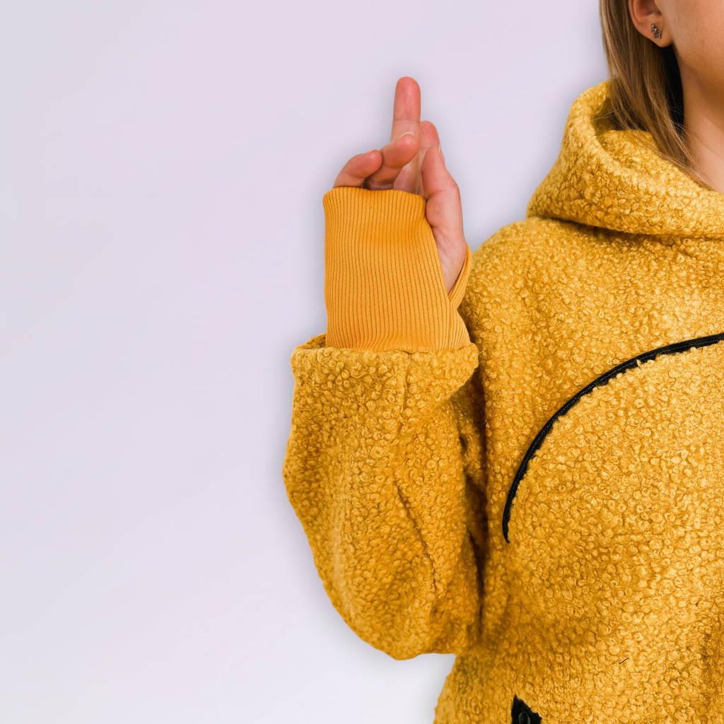 Person wearing a orange boucle fleece jacket with a white background
