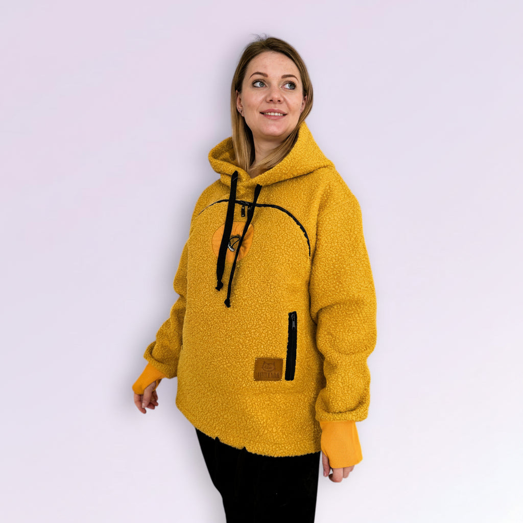 Woman wearing a orange fleece hoodie on a white background