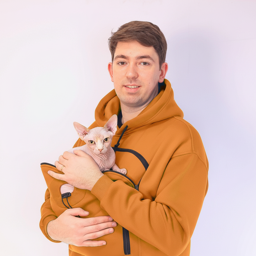 Man holding a small hairless cat  against a plain background