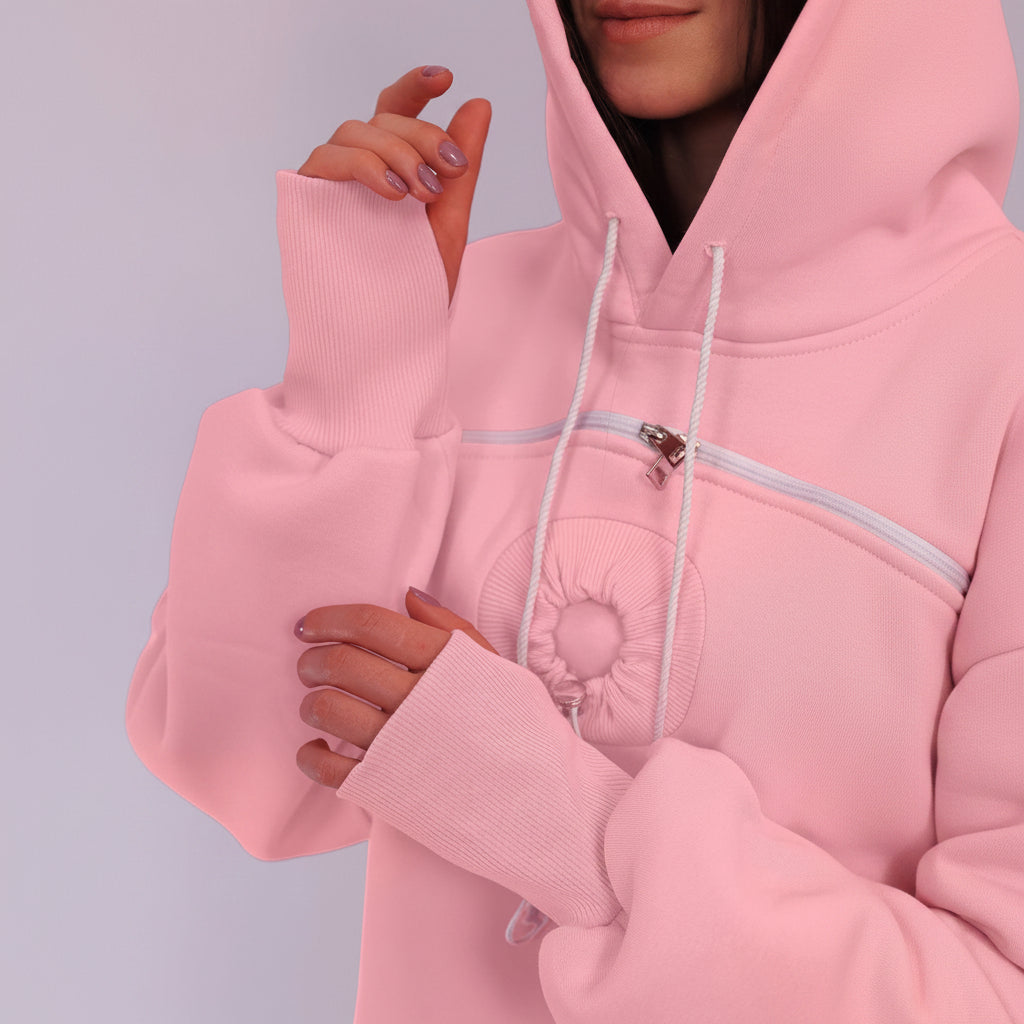Close-up of a pink hoodie with a zipper on a plain background