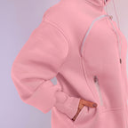 Close-up of a pink hoodie with a zipper on a light purple background