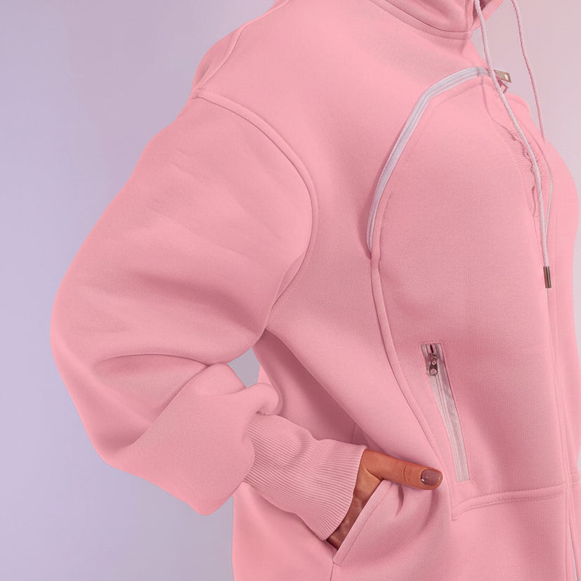 Close-up of a pink hoodie with a zipper on a light purple background