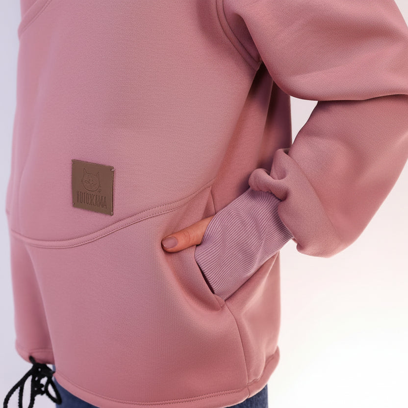 Pink sweatshirt with a brown label on a white background