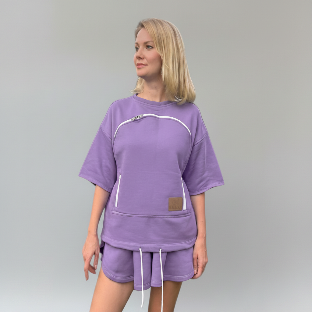 Woman wearing a purple outfit with white accents on a gray background