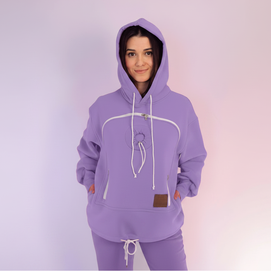 Person wearing a purple hoodie and pants on a light purple background