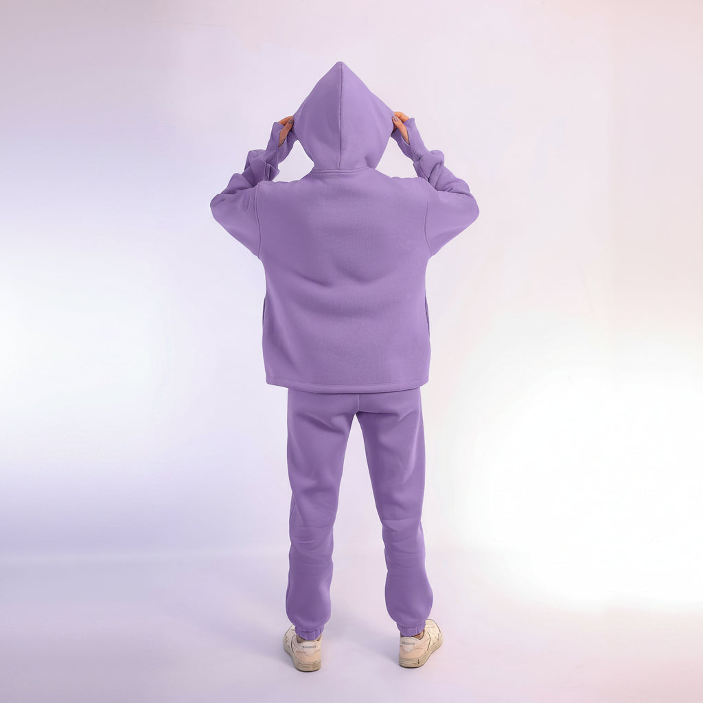 Person wearing a purple hoodie with a plain background