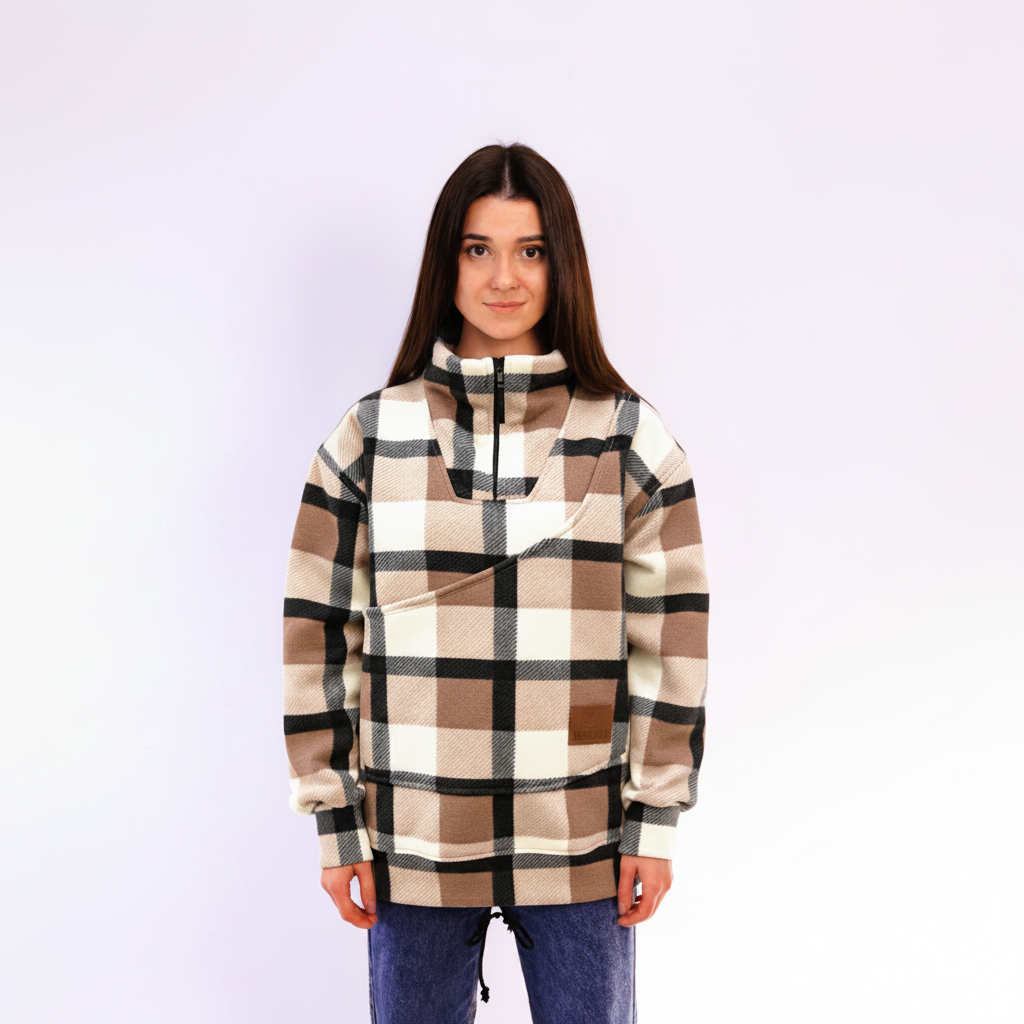 Woman wearing a beige plaid sweatshirt on white background