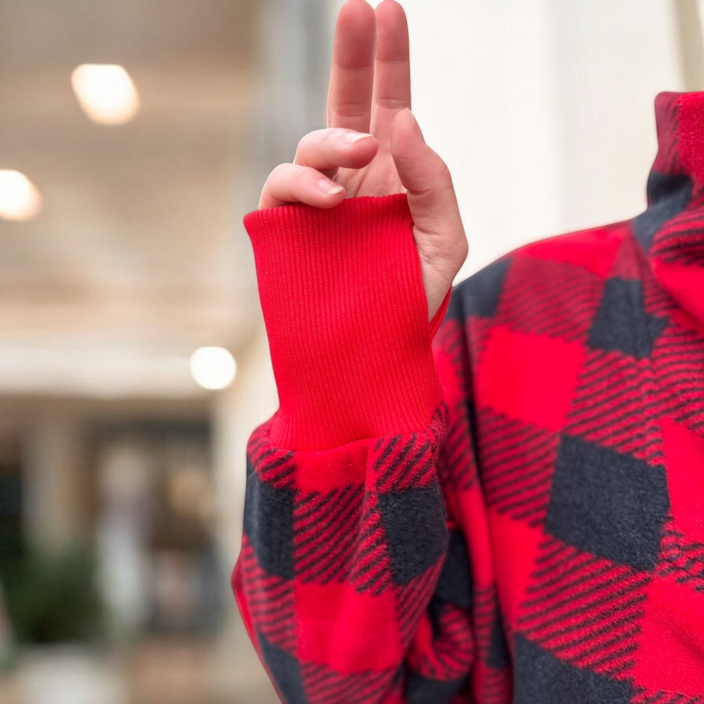 Person wearing a red square plaid sweatshirt 