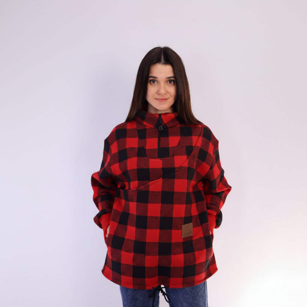 Women wearing a red square plaid sweatshirt on light background
