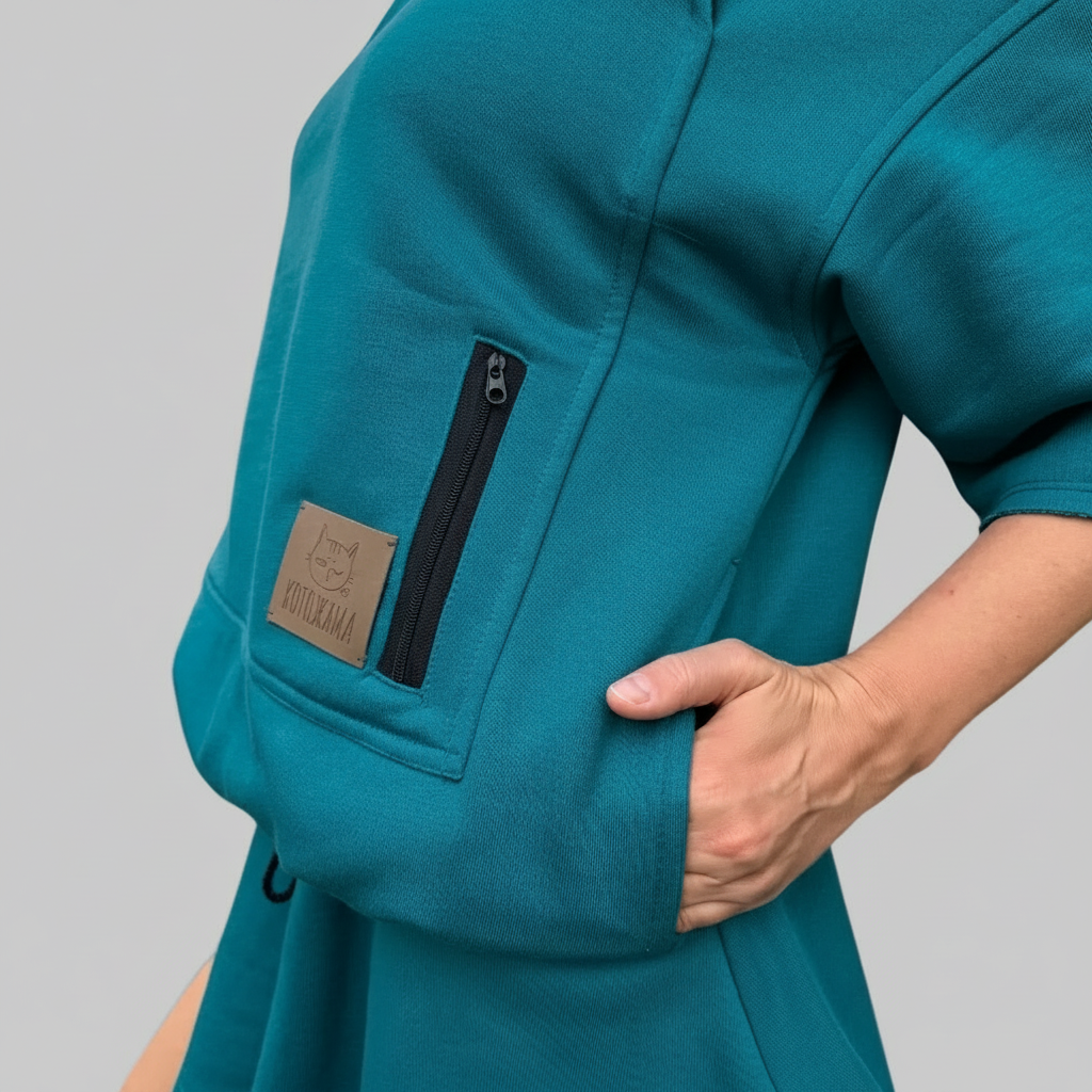 Teal shirt with a pocket and zipper on a gray background