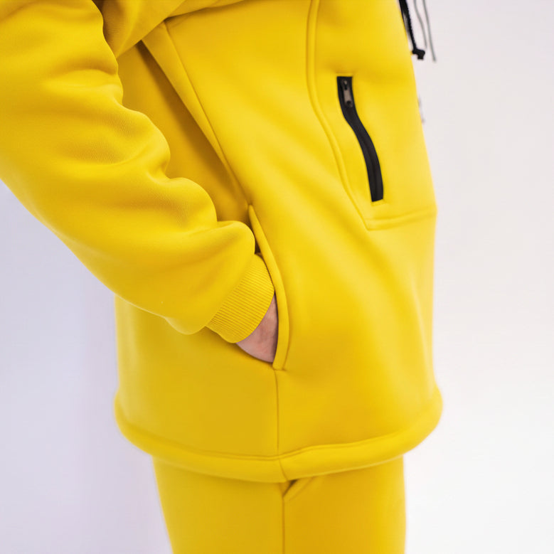 Yellow tracksuit with a black zipper on a white background