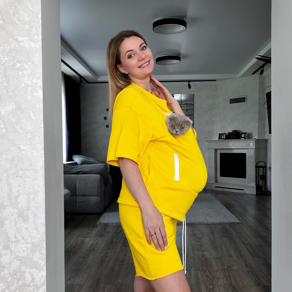 Woman in a yellow outfit standing in a modern living room.