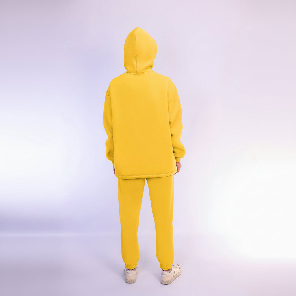 Person wearing a yellow tracksuit on a wight background